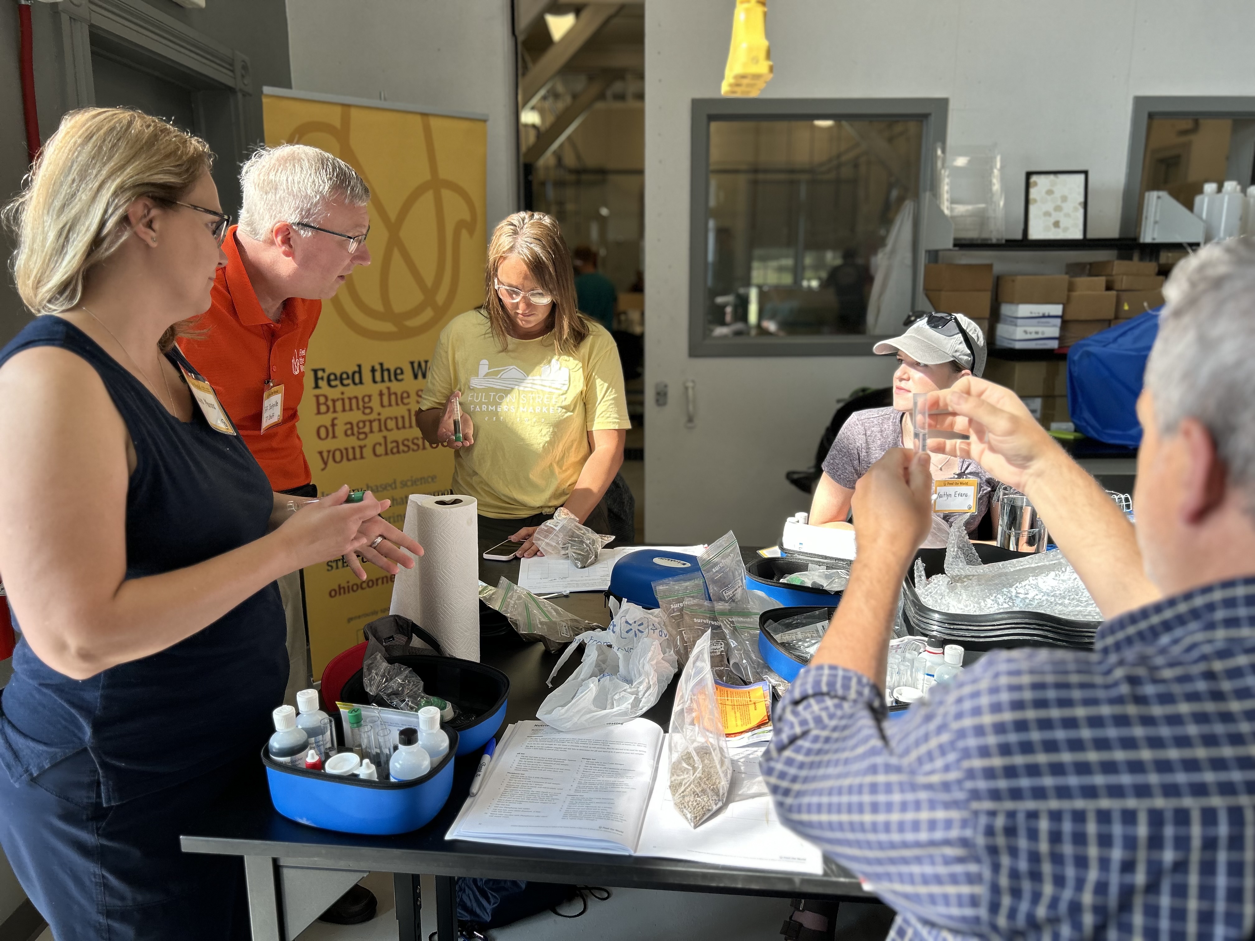 Heather Gilliland (center) tests water quality at Feed the World workshop.